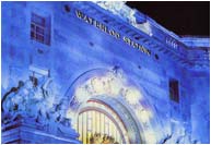 Waterloo Station, bronze halo lit sign. Floodlit with blue metals halide lighting
